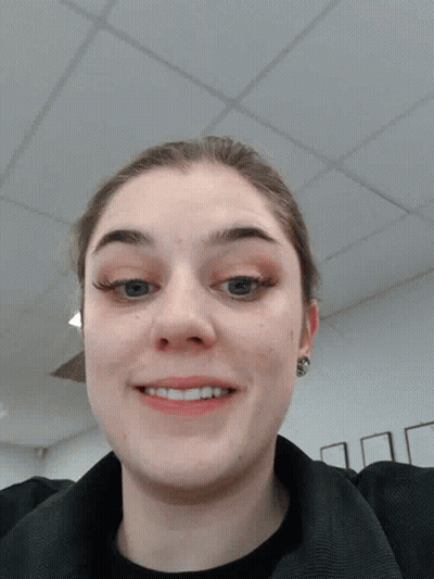 A Woman Making A Face With Her Tongue Out GIF