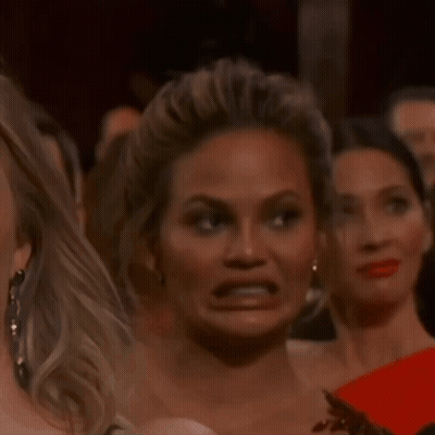 A Woman Making A Funny Face In A Crowd GIF