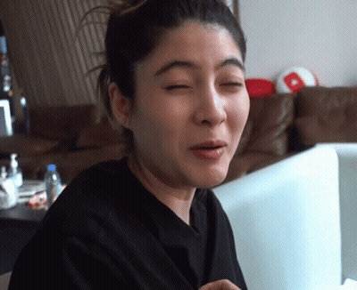 A Woman Making A Funny Face In Front Of A Computer Monitor GIF
