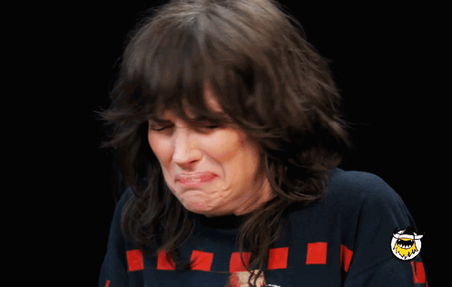 A Woman Making A Funny Face Wearing A Blue Shirt GIF