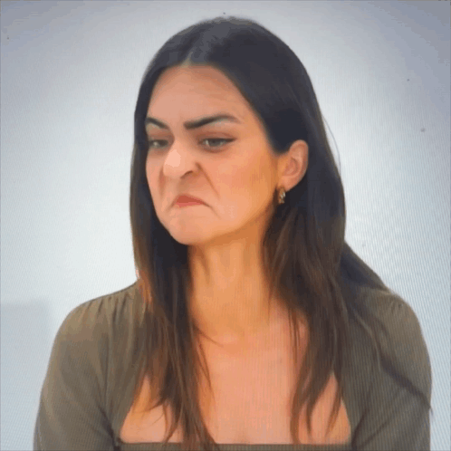 A Woman Making A Funny Face With Her Eyes Closed GIF