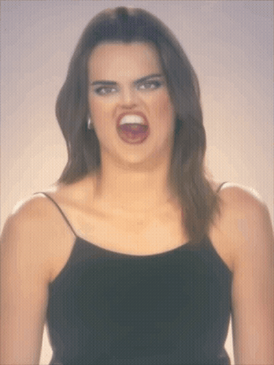 A Woman Making A Funny Face With Her Mouth Open GIF