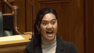 A Woman Making A Funny Face With Her Mouth Wide Open GIF