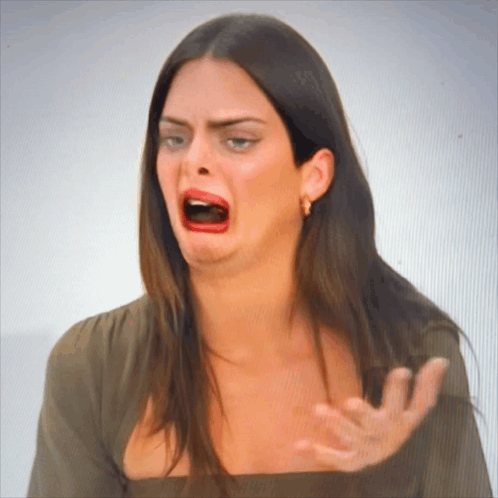 A Woman Making A Funny Face With Her Mouth Wide Open GIF