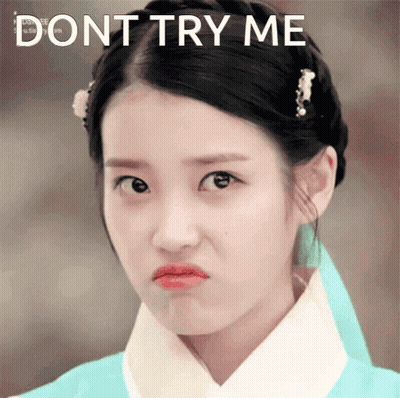 A Woman Making A Funny Face With The Words " Dont Try Me " Behind Her GIF
