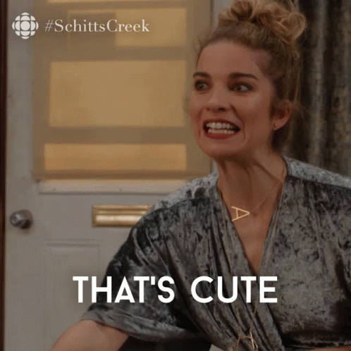 A Woman Making A Funny Face With The Words That 'S Cute Behind Her GIF