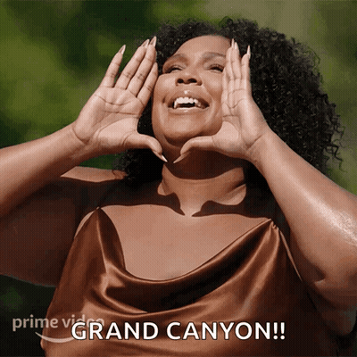 A Woman Making A Heart With Her Hands And The Words Grand Canyon On The Bottom Right GIF