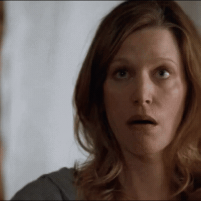 A Woman Making A Surprised Face With Her Mouth Open GIF