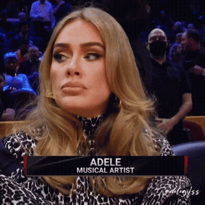 A Woman Named Adele Is Sitting In A Stadium GIF