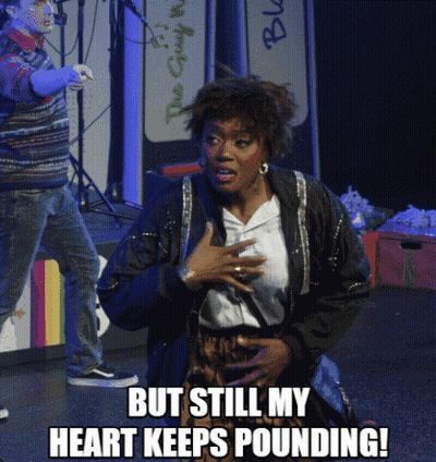 A Woman On Stage With The Words But Still My Heart Keeps Pounding On The Bottom GIF