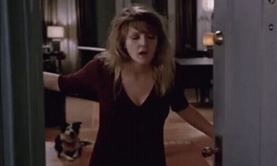 A Woman Opens A Door To A Room With A Dog On The Floor GIF