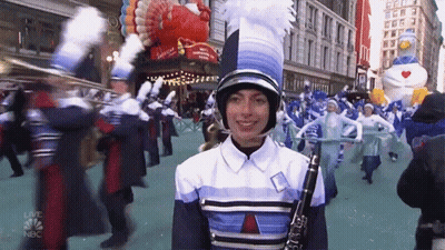 A Woman Playing A Clarinet In A Parade With Nbc Written On The Bottom Right GIF