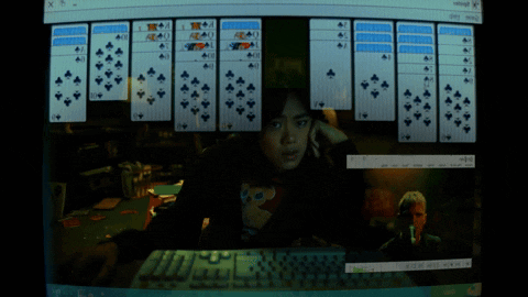 A Woman Playing A Game Of Solitaire On A Computer GIF