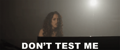 A Woman Playing A Piano With The Words " Do N't Test Me " Behind Her GIF