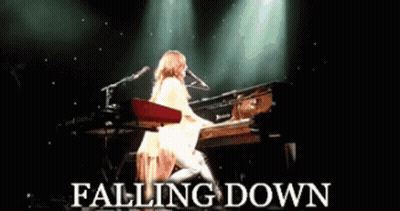A Woman Playing A Piano With The Words Falling Down Written Below Her GIF