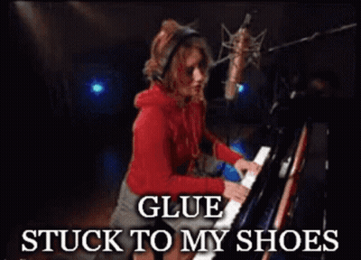 A Woman Playing A Piano With The Words Glue Stuck To My Shoes Below Her GIF