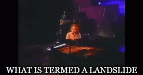 A Woman Playing A Piano With The Words " What Is Termed A Landslide " Written Below Her GIF
