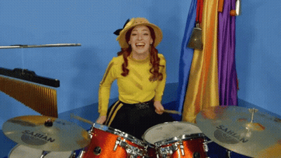 A Woman Playing Drums With Sabian Cymbals In Front Of Her GIF