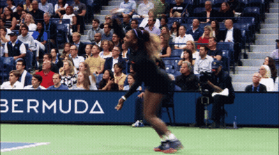 A Woman Playing Tennis In Front Of A Banner For Bermuda GIF