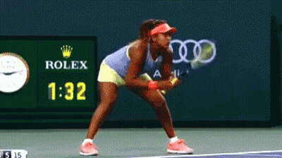 A Woman Playing Tennis In Front Of A Rolex Ad GIF