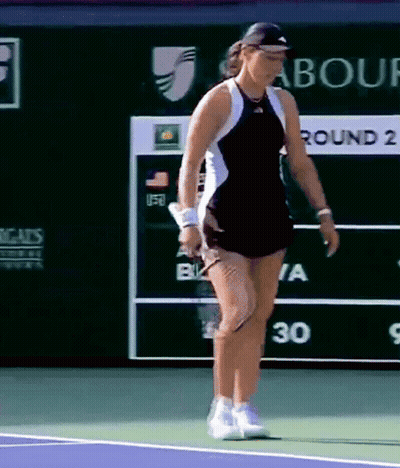 A Woman Playing Tennis In Front Of A Scoreboard That Says " Round 2 " GIF
