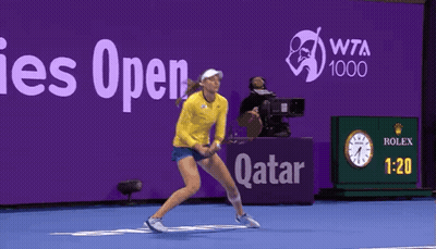 A Woman Playing Tennis In Front Of A Sign That Says Wta 1000 GIF