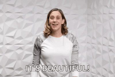 A Woman Pointing At The Camera With The Words You Rock It 'S Beautiful Behind Her GIF