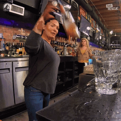 A Woman Pouring A Drink In A Bar With A Sign That Says Bar Rescue GIF
