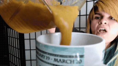 A Woman Pouring Something Into A Mug That Says March 20 On It GIF