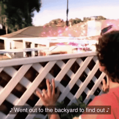 A Woman Reaches Out To Touch A White Lattice Fence With The Words " Went Out To The Backyard To Find Out " Above Her GIF