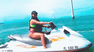 A Woman Riding A Yamaha Jet Ski In The Ocean GIF