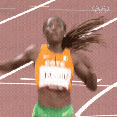 A Woman Running On A Track With The Name Ta Lou On Her Jersey GIF