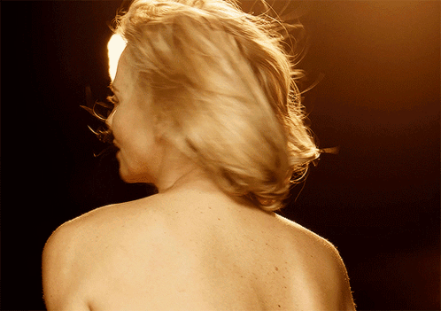 A Woman 'S Back Is Shown In A Close Up GIF