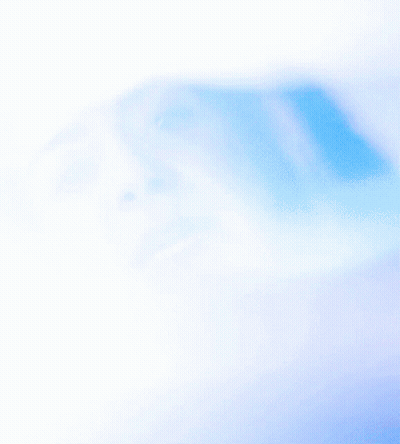 A Woman 'S Face Is Partially Obscured By A Blue Light GIF