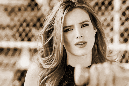 A Woman 'S Face Is Shown In A Black And White Photo With A Fence In The Background GIF