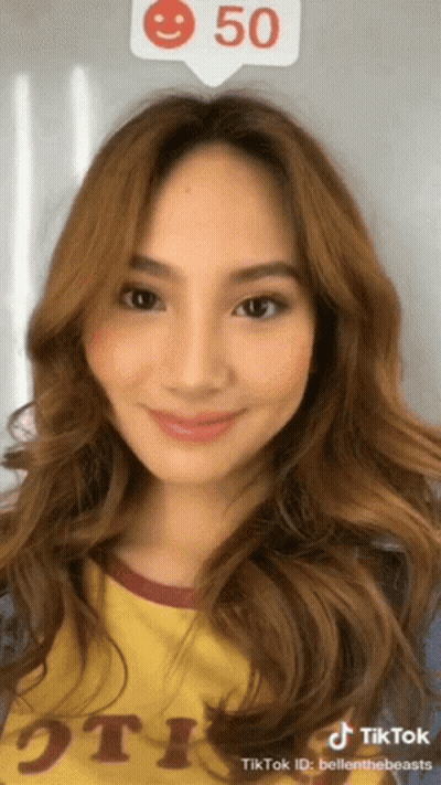 A Woman 'S Face Is Shown In A Tiktok Video With A Smiley Face Above Her Head GIF