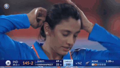 A Woman 'S Face Is Shown On A Television Screen During A Cricket Match Between India And Nz GIF