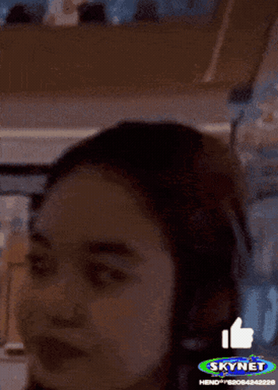 A Woman 'S Face Is Shown With A Skynet Logo In The Background GIF