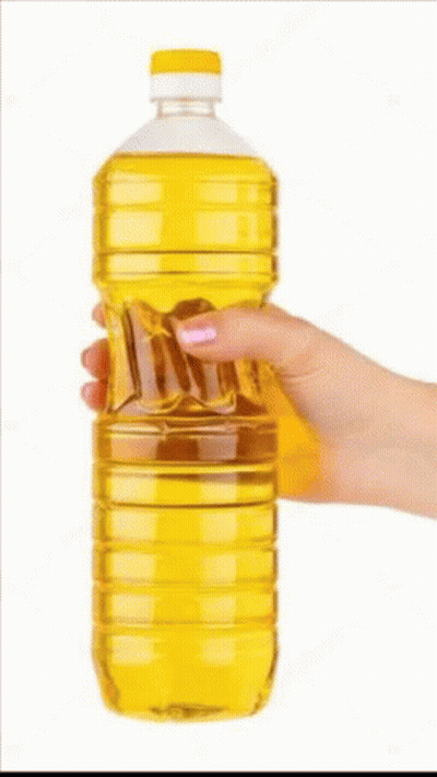 A Woman 'S Hand Is Holding A Bottle Of Oil . GIF
