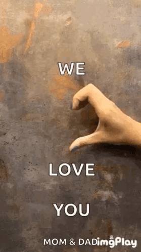 A Woman 'S Hand Is Making A Heart Shape With Her Fingers On A Wall . GIF