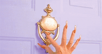 A Woman 'S Hand With Long Nails Is Knocking On A Door . GIF