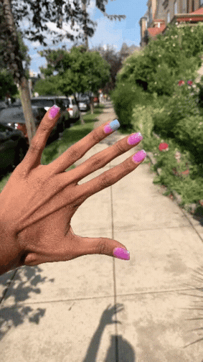 A Woman 'S Hand With Pink And Blue Nails GIF