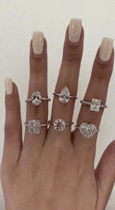 A Woman 'S Hand With Several Rings On It GIF