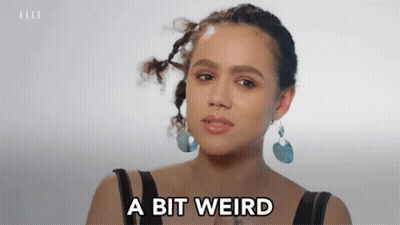 A Woman Says A Bit Weird In Front Of Her Face GIF