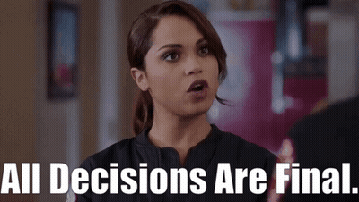 A Woman Says " All Decisions Are Final " In Front Of A Red Wall GIF
