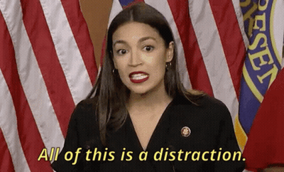A Woman Says All Of This Is A Distraction While Standing In Front Of American Flags GIF