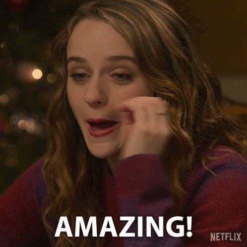 A Woman Says Amazing In Front Of A Netflix Sign GIF