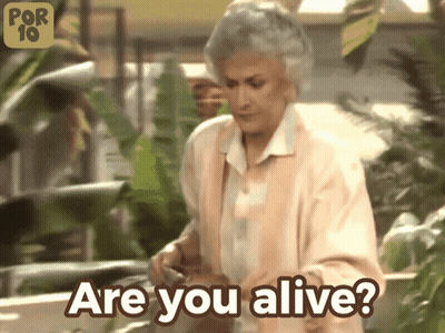 A Woman Says " Are You Alive " In Front Of Plants GIF