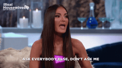 A Woman Says Ask Everybody Else Do N't Ask Me While Sitting On A Couch GIF