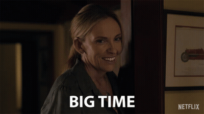 A Woman Says Big Time In Front Of A Picture Of A Motorcycle GIF